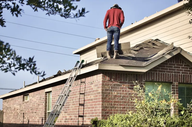 Professional roofer working on a residential roof in Spyglass Hill